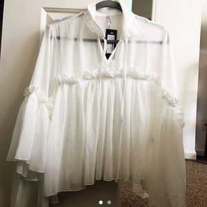 White ruffled blouse from Nasty Gal